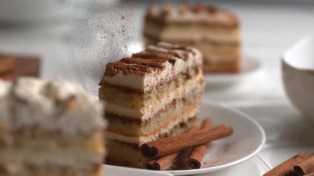 Cinnamon sprinkled onto Tiramisu cake in super slow motion, shot on Phantom Flex 