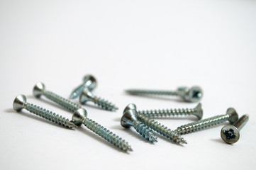 A bunch of screws on a white background