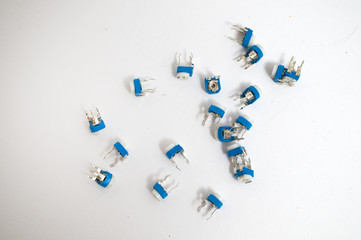 A bunch of white blue potentiometer on a white background