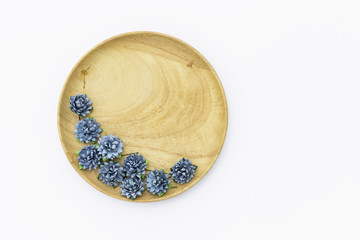 Blue paper flower on round wooden tray isolate on white background