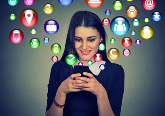 Woman using smartphone with application icons flying out of screen