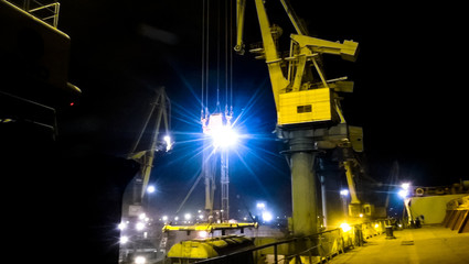 Industrial seaport at night. The rotation of the car with grain