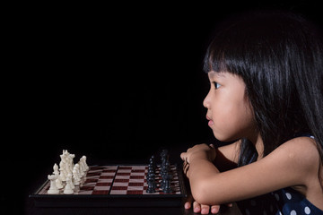 Asian Little Chinese girl playing chess