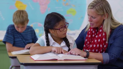Teacher and student looking up word in dictionary together - Powered by Adobe