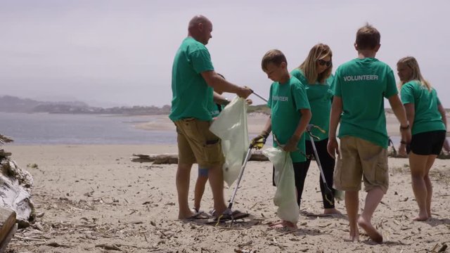 Group of volunteers cleaning up beach