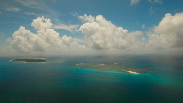 Aerial view of beautiful tropical island Daco with white sand beach. View of a nice tropical beach from the air. Beautiful sky, sea, resort. Seascape: Ocean and beautiful beach paradise. Philippines