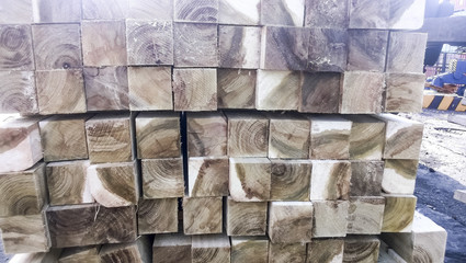 Wooden bars, neatly folded into rows. Wooden plank. View from th