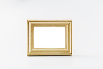 Blank gold picture frame on white background