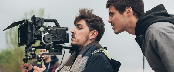 Behind the scene. Cameraman and film director shooting film scene