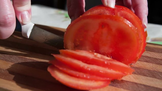 knife sliced red tomato into thin pieces