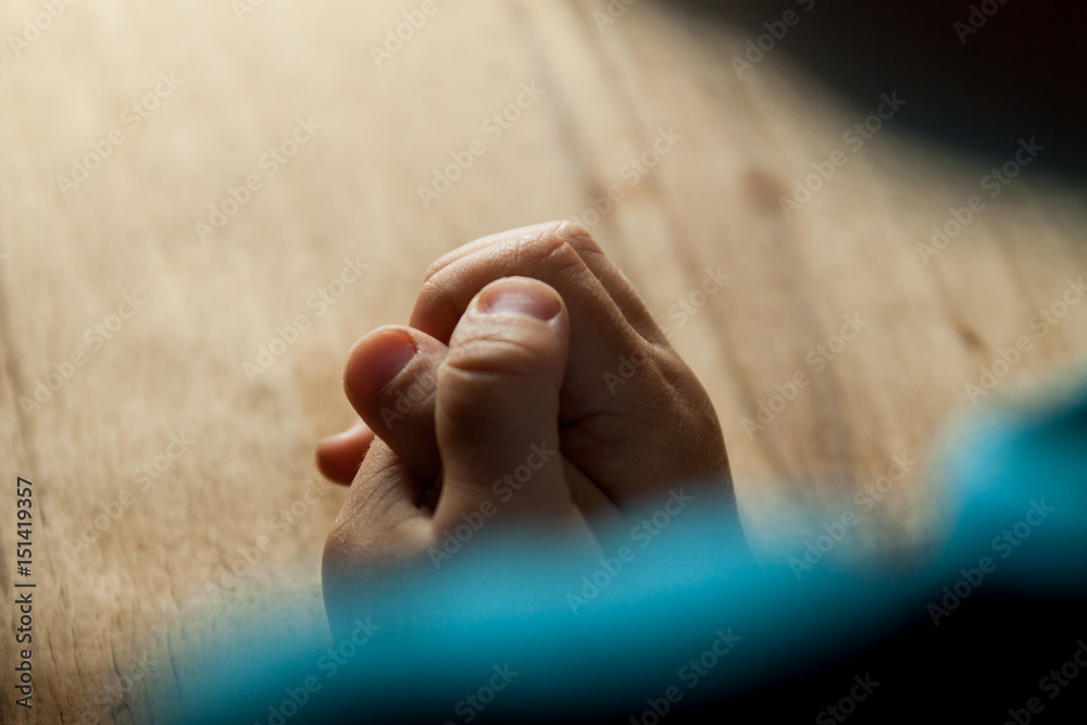 Wall mural Child hands folded for prayer