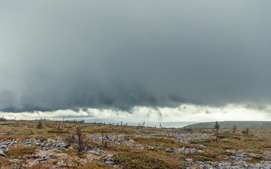 Ural mountains, bad weather, approaching thunderstorm, storm, field with stones. sunset colors, beautiful sky