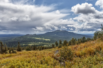 mountain landscape, the Ural Mountains, grass and mountain ranges, the weather changes, are storm clouds