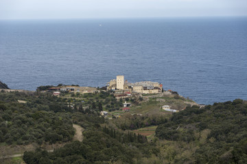 Fototapeta na wymiar Distance view of a Monastery on The Holy Athos Mountain, Greece; seaside, spring time
