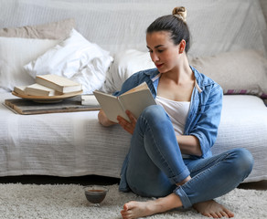 girl reading a book in a cozy room