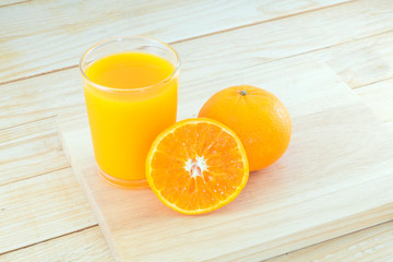 Close-up ripe orange on wood background.