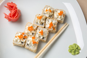 Delicious pieces of sushi, on white background
