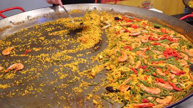 Large dish of Paella on a seafood market stall
