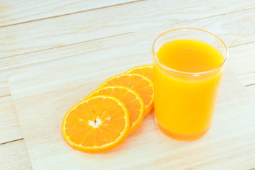 Close-up ripe orange on wood background.
