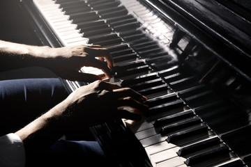 Afro American man hands playing piano