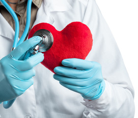 Female cardiologist in uniform holding red heart isolated on the white background