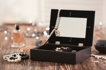 Jewelry and box on wooden table
