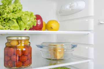 Open fridge full of fresh fruits and vegetables
