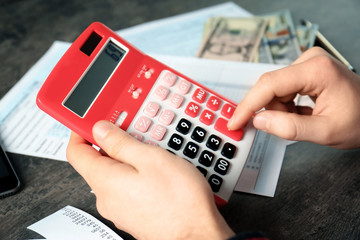 Man working with calculator and documents. Tax concept