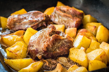 Shot of pork roasted with morel mushrooms and potatoes