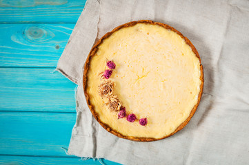 Homemade cheesecake - healthy organic summer dessert pie cheesecake. Cheese cake on blue wood table.