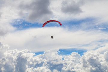 Paragliding in the massive cloudy sky