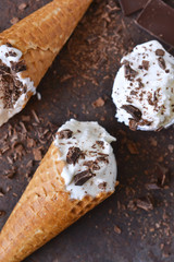Vanilla ice cream cone with chocolate on an old grunge background