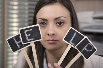 Business woman cheering for help, hiding behind the sign