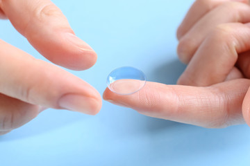 Female hands with contact lens, closeup