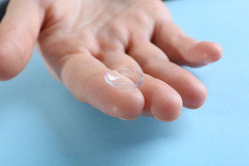 Contact lens on finger, closeup