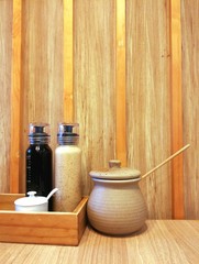 Bottles and jar of Japanese condiments on wooden background