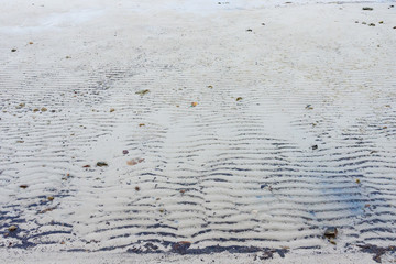 Sand waves texture on the beach.