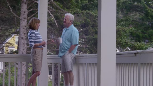 Senior couple having coffee on porch together