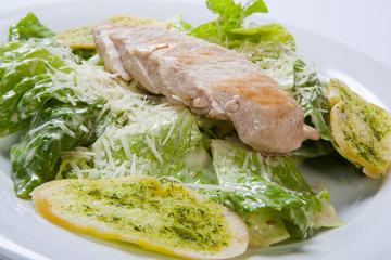 Caesar salad plate with cheese and garlic bread
