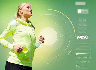 young woman with earphones running over green