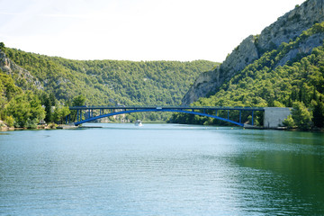 A bridge is connecting a part of an island so that cars can drive from one side to another easily.