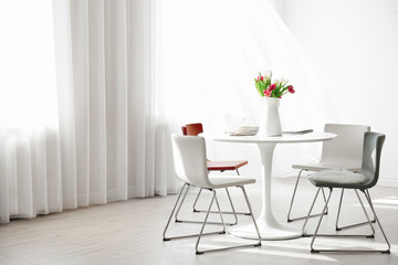 Modern living room with table and chairs