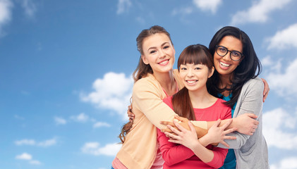 international group of happy women hugging