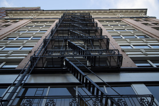 Dramatic Upward Skyward View, Tall City Building, Brick Front, Black Fire Escape/Stairs, Daytime - Portland, Oregon