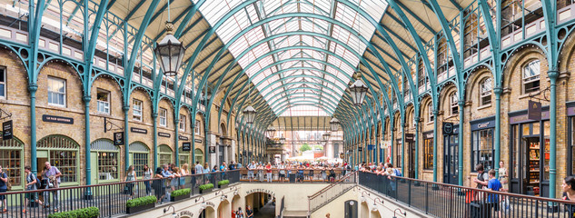LONDON - JUNE 2013: People in Covent Garden. London is visited by 30 million people annually