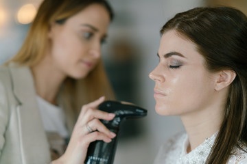 Applying air brush make-up