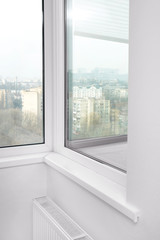 Fototapeta na wymiar Modern white plastic window at home
