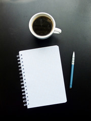 Obraz na płótnie Canvas Coffee cup and notebook