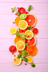 Citrus slices on color wooden  background