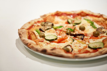 close up of pizza on plate at pizzeria
